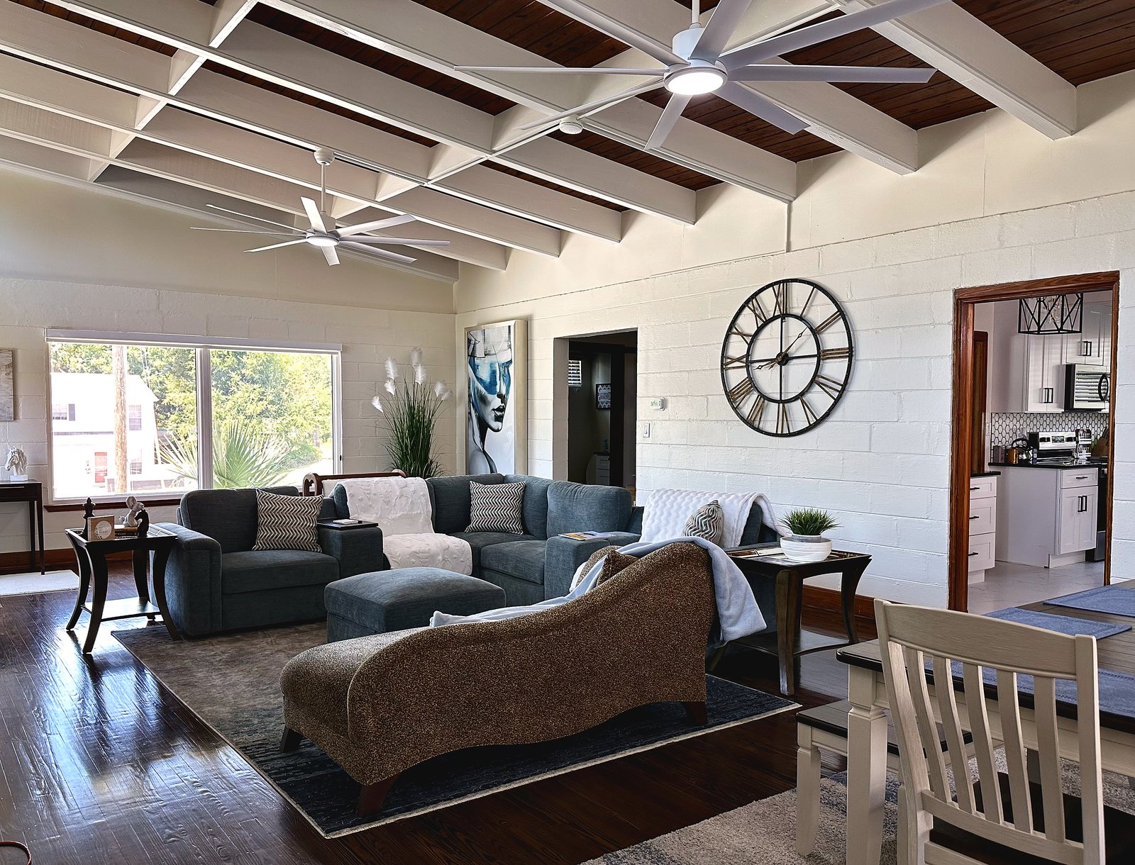 The great room seating area beneath the wood ceiling