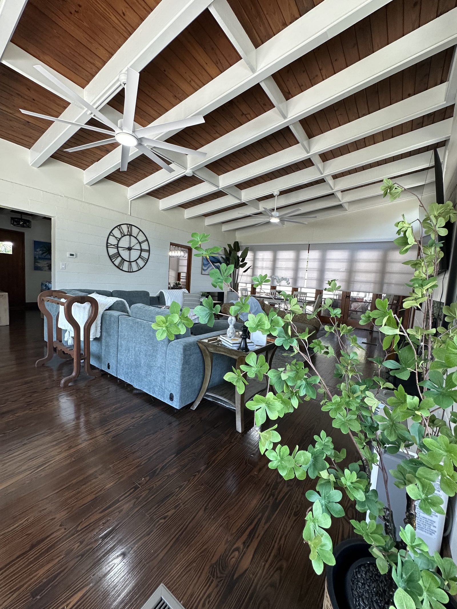Seating in the great room beneath the wood ceiling